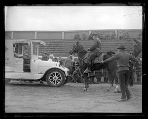 A man on horseback looking at a man on the ground