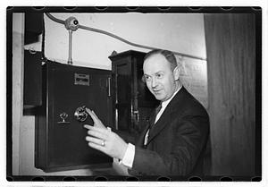 A man demonstrating how to break into a safe