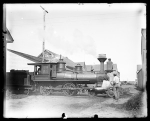 Woodburning locomotive at crossing