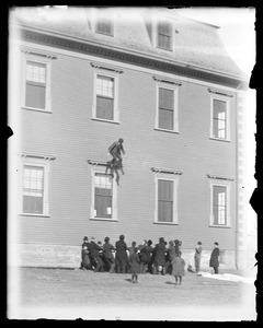 Men jumping from Agricultural Hall into life net