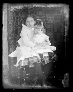 Unidentified young girl and doll