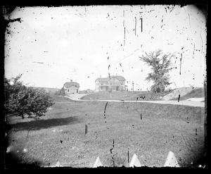 Distant view of unidentified house and barn