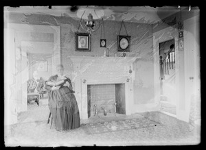 Woman sitting next to fireplace reading a book