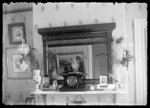 Interior of a home with view of one wall and mantle, fireplace with mirror