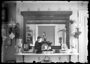 Interior of home showing mantle, fireplace with mirror
