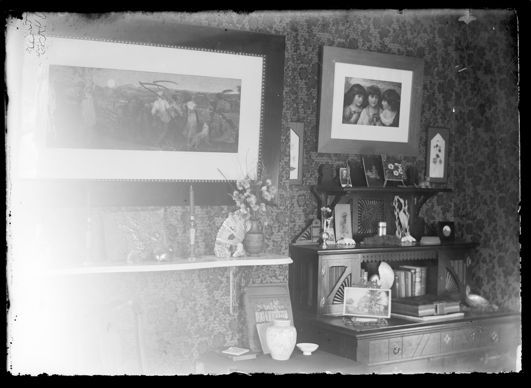Scene of one wall inside a home with desk and pictures