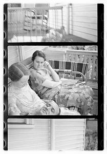 People, including Maude Sanromá, seated on a porch