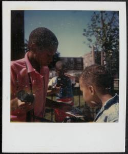 Boys using cameras in Newtowne Court