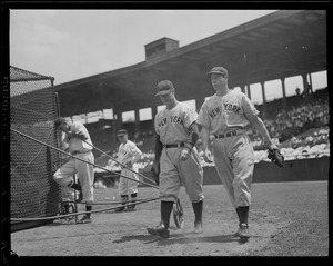 Lou Gehrig and Joe DiMaggio walk by batting cage at Fenway