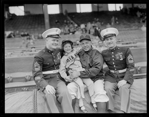 New York Giants Eddie Stanky poses with child and two marines
