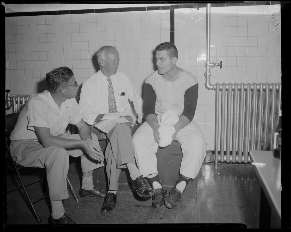 Reporter interviews baseball player in locker room