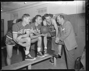 Red Auerbach in locker room with three Celtics