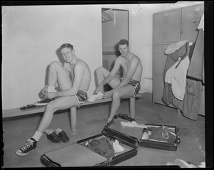 Two players suiting up in locker room