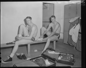 Two players suiting up in locker room