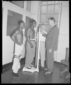 Jimmy Carter, on scale, and challenger Bud Smith weigh in before lightweight fight, Boston Garden