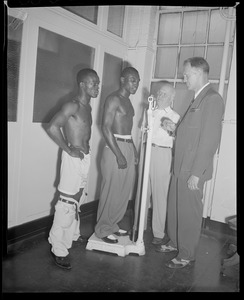 Jimmy Carter, on scale, and challenger Bud Smith weigh in before lightweight fight, Boston Garden