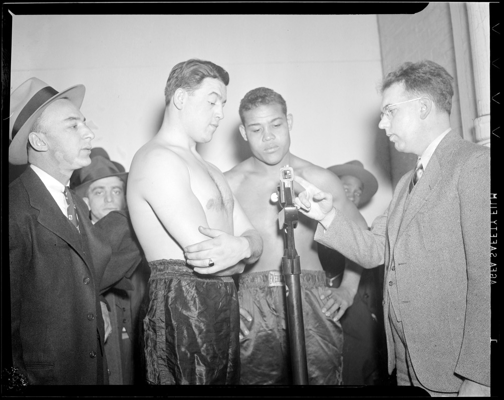Al McCoy weighs in while Joe Louis looks on, at Boston Garden