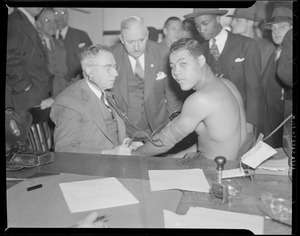 Joe Louis gets blood pressure checked before Al McCoy fight at Boston Garden