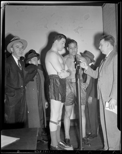 Joe Louis watches Al McCoy weigh in before fight at the Garden