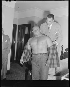 Jack Dempsey clowns with wrestler Yukon Eric at the Hotel Touraine
