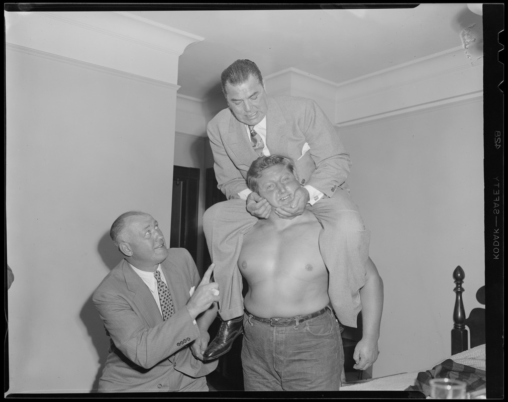 Jack Dempsey, Jack Sharkey and Paul Bowser clown with wrestler Yukon Eric