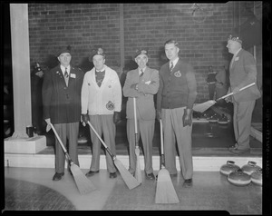 Curling: Four curlers pose with brooms next to ice