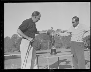 Walter Hagen, right, admires trophy for Boston area tournament with fellow golfer