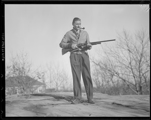 "Jug" McSpaden with shotgun, at home in Arlington