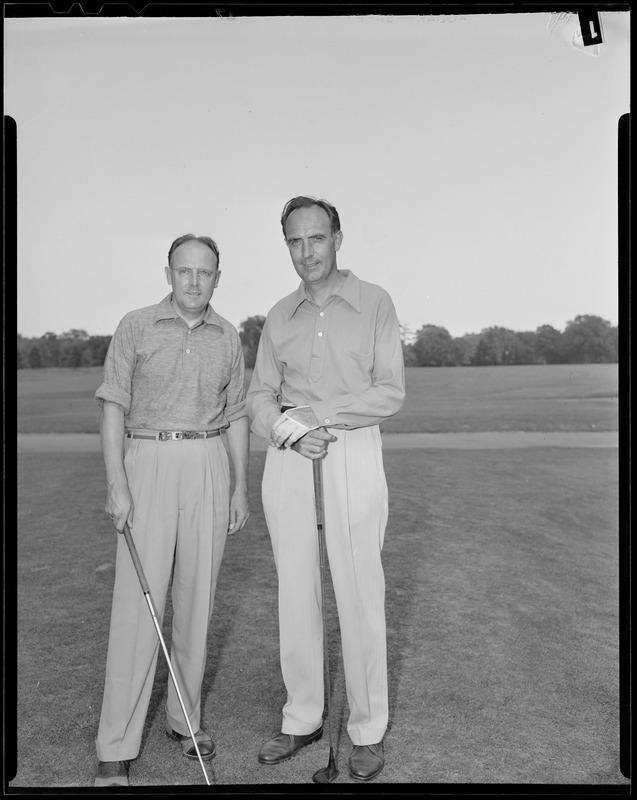 Two men pose on course