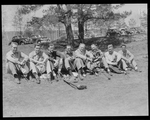 Group of golfers seated on grass