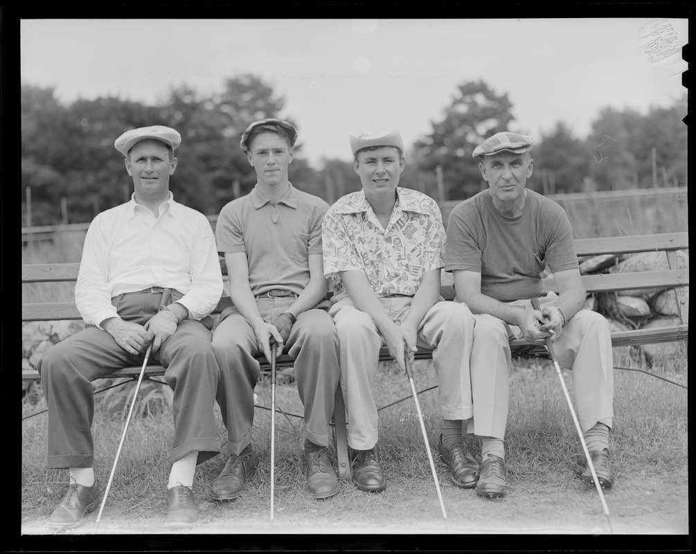 Four golfers on bench