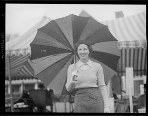 Woman golfer with umbrella