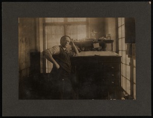 Man Leaning on his Work Desk