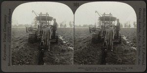 Digging ditch with tractor and laying drain tile, Wisconsin