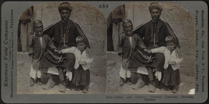Father and children, showing costumes, Ramallah, Palestine