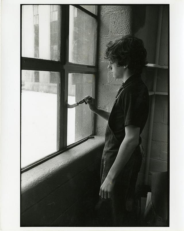 Boy painting a window frame - Digital Commonwealth