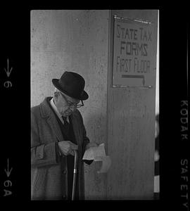 Old gentleman checks his tax form, Beacon Hill, Boston