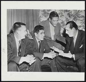 Three Indians and the Chief- Cleveland Pitching Big Three of (left to right) Bob Lemon, Mile Garcia and Early Wyn talk with General Manager Hank Greenberg (right) at the Cleveland Writers banquet last nigh. Greenberg is trying to sign the trio for a total of $100,00.