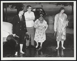 Charles St. or River?----Dignified Bostonians go barefoot on Charles St. which was turned into one long puddle.