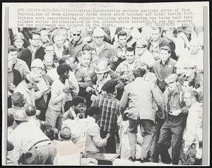 Chicago: White construction workers surrounded group of four Negroes, one of whom allegedly fired shots which touched off brief battle 9/25. Workers were demonstrating outside building where hearing was being held into alleged racial discrimination in the construction industry. No one was wounded but one policeman was injured in the fight.