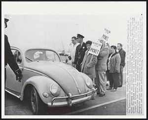 Sunnyvale, Calif. – Pickets At Lockheed Plant – Pickets of the International Association of Machinists allow car of non-striker to enter grounds of the Lockheed Aircraft Co. at Sunnyvale, Calif., today, after the union struck the plant in a contract dispute. The picket line formed at 12:01 aspt. A company spokesman acknowledged a slow down in production but said the plant would remain open. Key projects at the Sunnyvale plant include production of the U.S. Navy’s Polaris submarine missile and the Agena satellite vehicle.