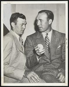 Red Ruffing (right), who was to pitch the opening game of the series against the giants, shown discussing plans with catcher Bill Dickey, his Yankee battery mate.