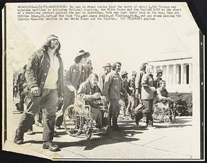 Two men in wheel chairs lead the march of about 1,000 Vietnam war veterans marching to Arlington National Cemetery, the White House and the Capitol 4/19 at the start of a week-long protest against the war in Indochina. Both men lost their legs in the war. They are William Wyman, 20, left, of New York City, and James Dehlin, of Flushing, Mich., and are shown passing the Lincoln Memorial enroute to the White House and the Capitol.