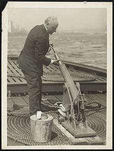 Photo of Max Rindskopf and His Life Saving Gun A Gun to Save; Not to Kill! New Item Max Rinskoff, Inventor, on the New York City Police Boat "Hylan" Demonstrating How His G-0 Life Line Hurling Gun Works. The Gun Shoots a Life Line Accurately 1,400 Feet and Has the Highest Commendation of the U.S. Stealboat Inspection Board. The Powder Used in Inclosed in an Air and Water-Tight Cartridge and the Gun is Said Never to Mis-Fire and to Have Very Little Recoil.