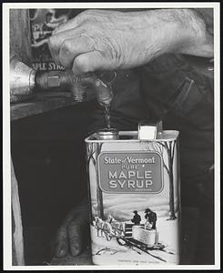 Filling the cans with maple syrup.