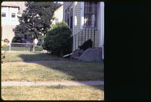 A boy heading toward steps to a house