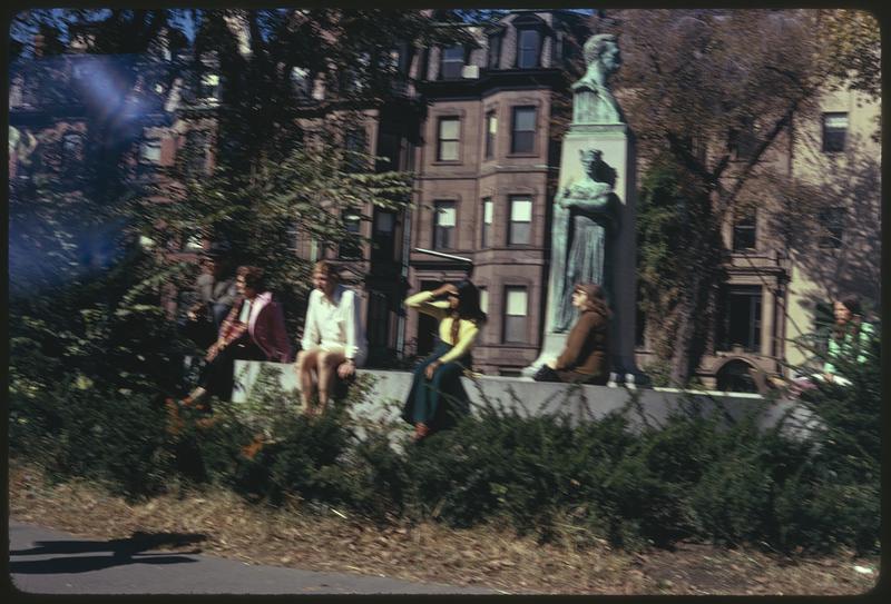 People sitting by bust of Patrick Collins, Commonwealth Avenue, Boston Columbus Day Parade 1973