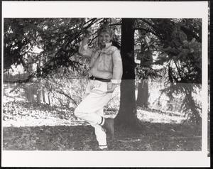 Young woman posing beneath tree