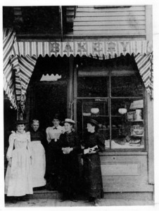 In front of Harrison's Bakery at the corner of 61 Main and Church Streets, 1900.