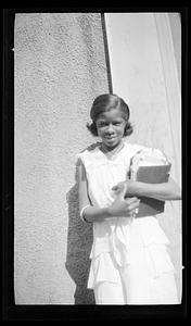 Constance Miller stands with books in her arms